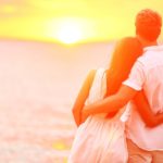 Honeymoon couple romantic in love at beach sunset