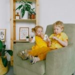 A Photo Of Siblings Eating Grapes