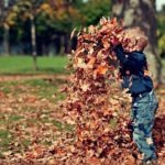 boy-playing-with-fall-leaves-outdoors-1