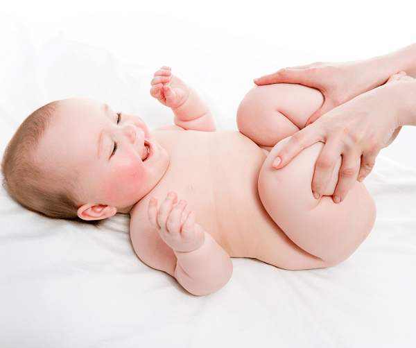 mother massaging baby for relieving constipation